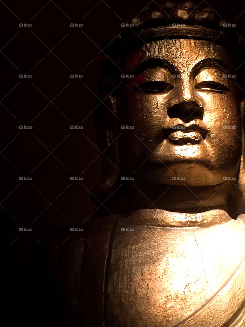 Meditation. A statue of Buddha in spotlight at a meditation hall.