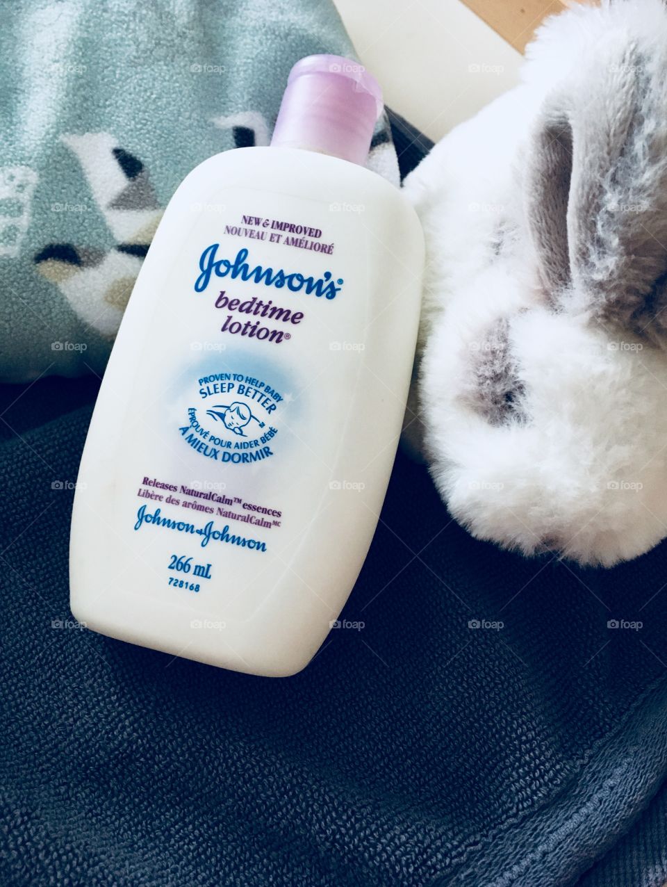 Time to get baby ready for bed. Johnson’s bedtime lotion, stuffed white and grey bunny. 