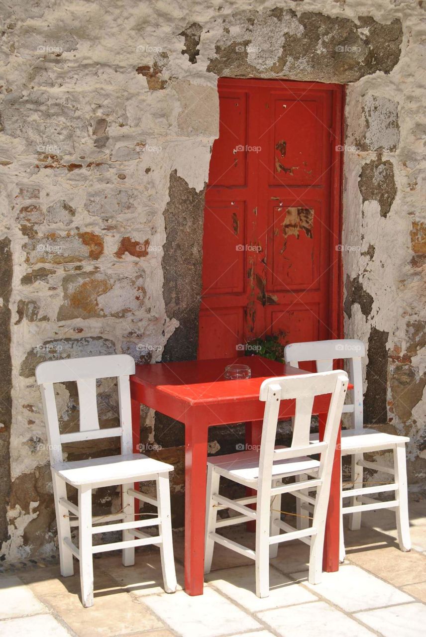 little terrace in white red with old wall in a alley