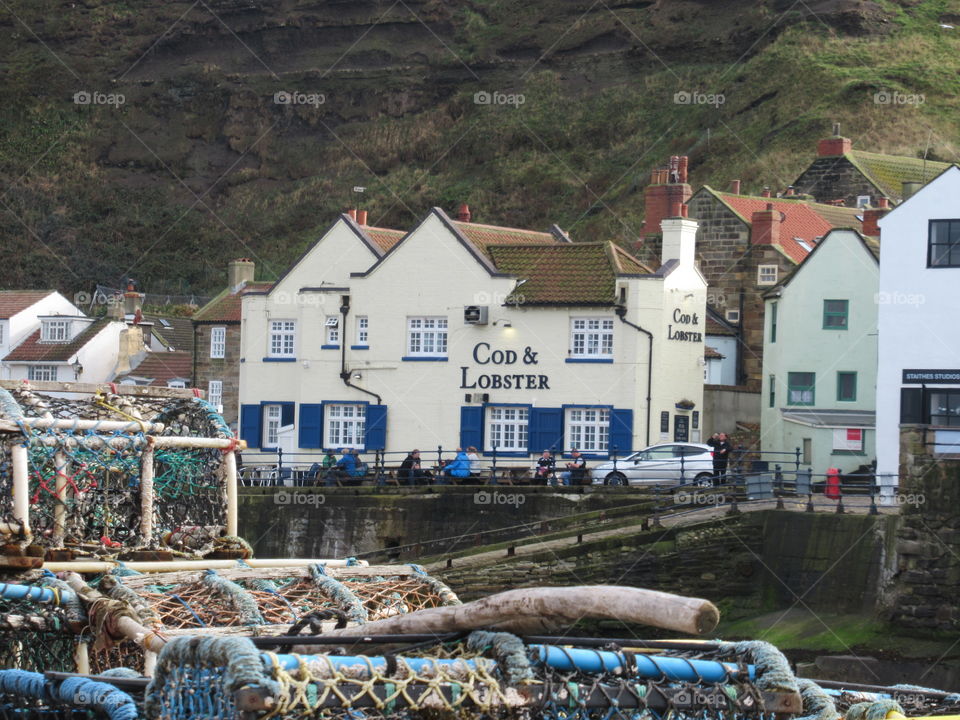 lobster nets and view of the cod and lobster pub at staithes a small fishing village north yorkshire