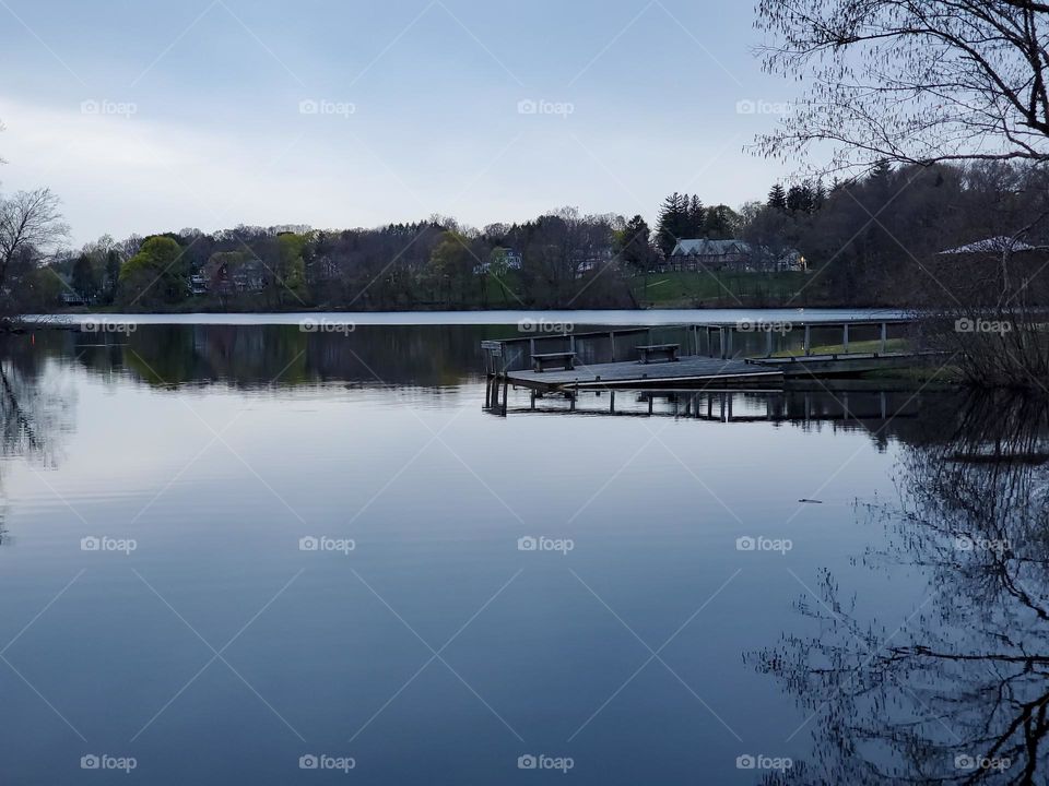 A dock juts out into a calm lake