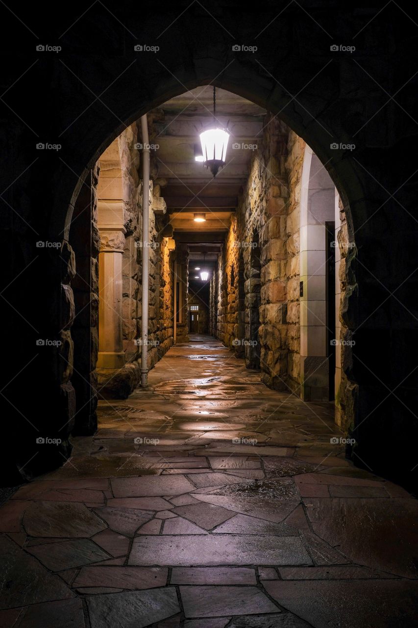 Foap, Day and Night: A Gothic style exterior corridor at the All Saints Chapel at the University of the South on a cold wet night. 