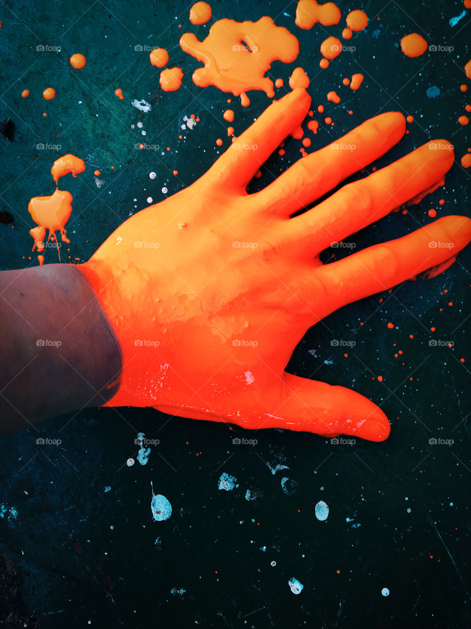 Human hand dipped in neon color