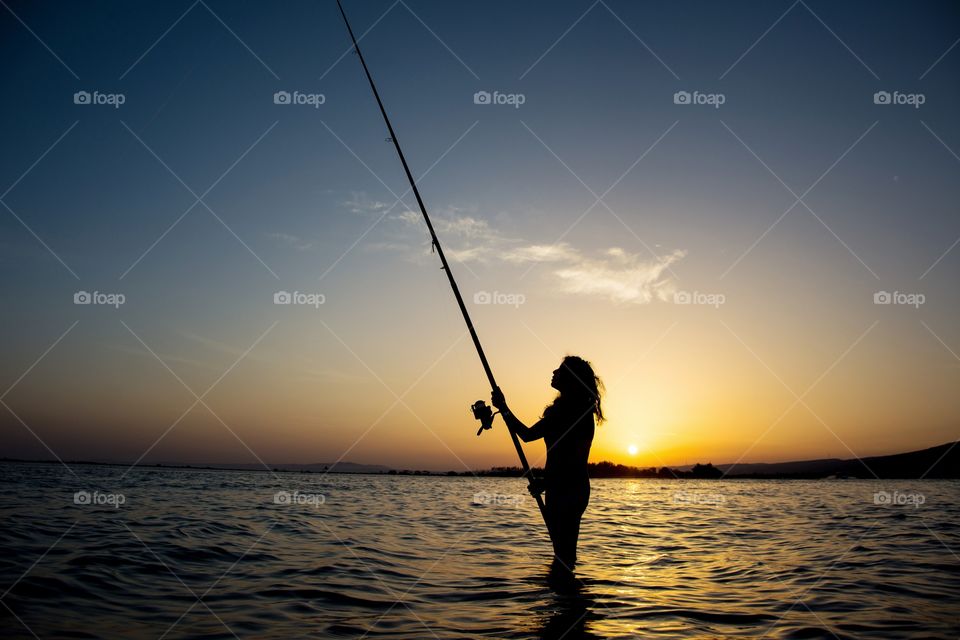 silhouette of a fiahing girl