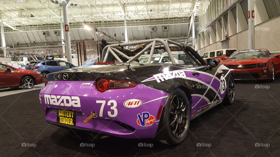 Mazda Miata Cup race car on display at an Auto Show.