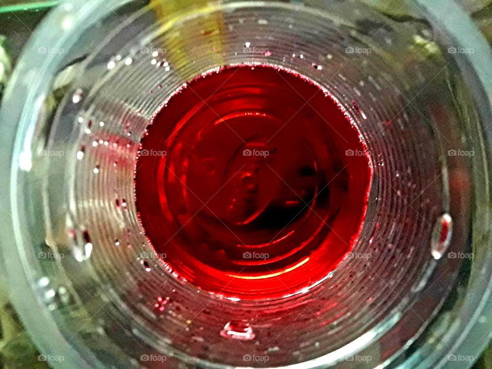 Red colors littile H2O in a plastic glass