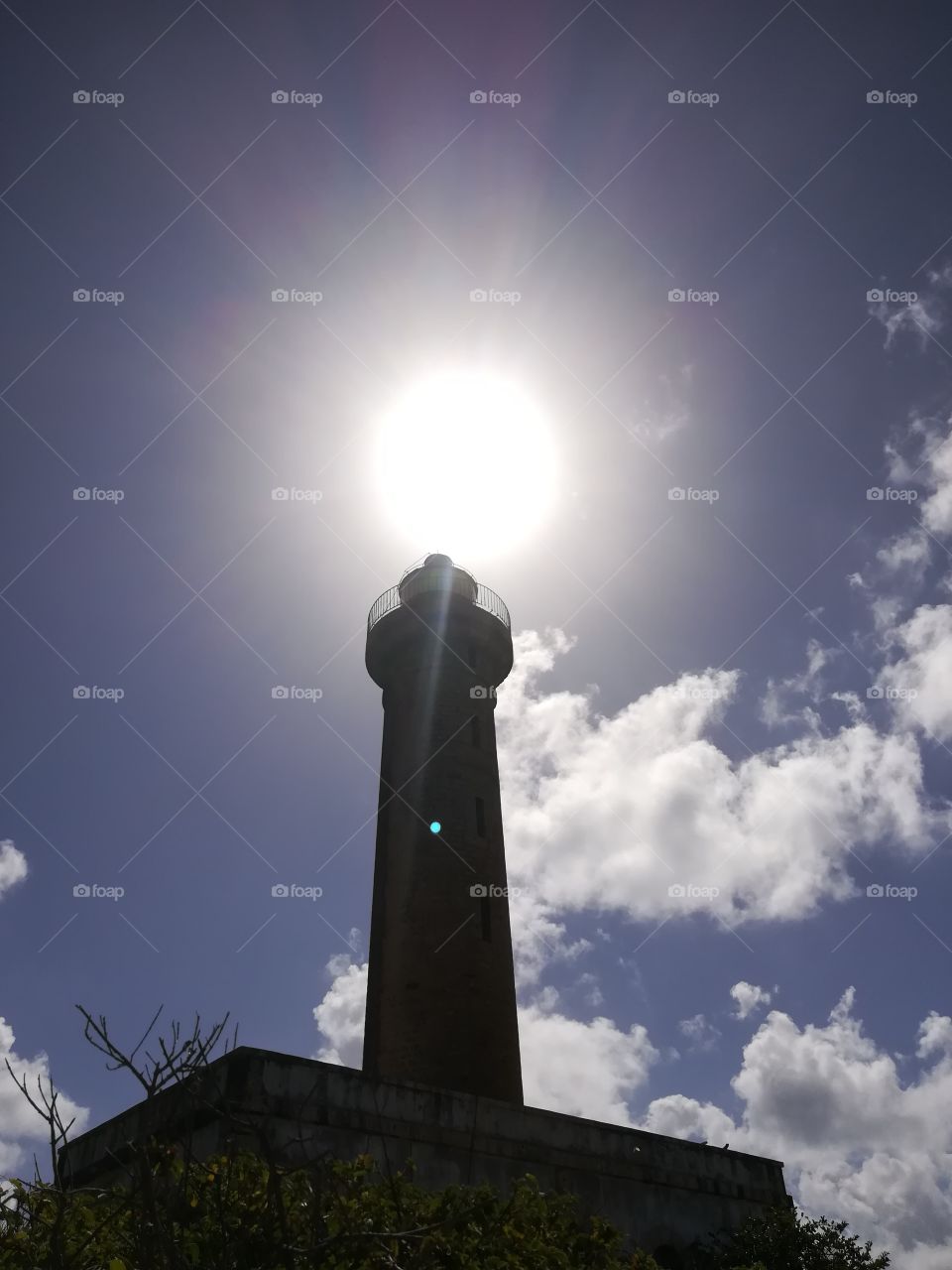 A lighthouse superimposed on the sun in Petite Terre in Guadeloupe