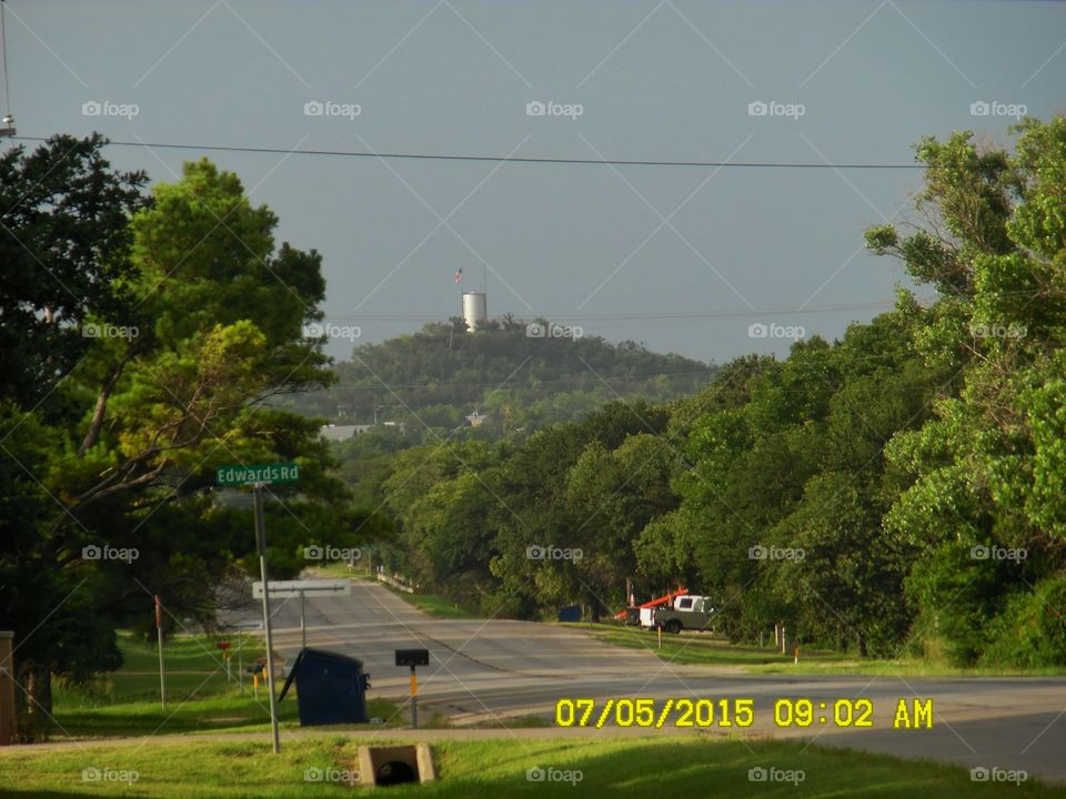 American 🐮 flag. I love this picture of the water 💦 tower 🗼 in the background that I saw while out walking 🚶 🏃 🔥 💨