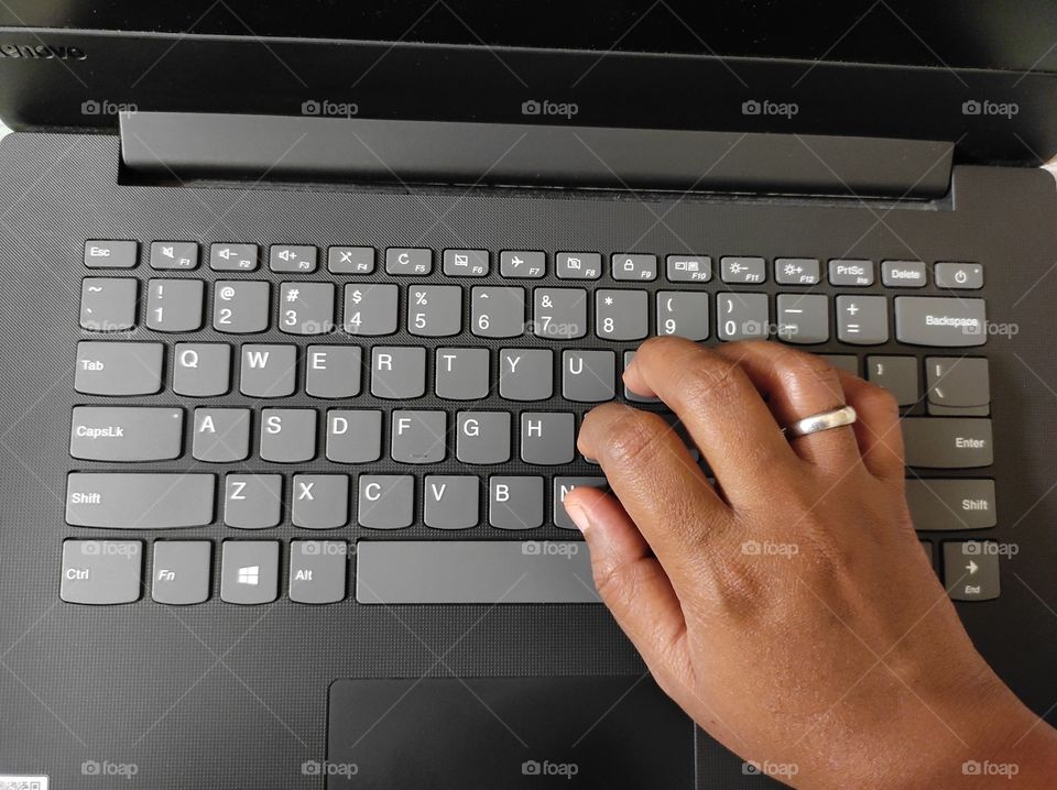 Hands of a person typing in the keypad