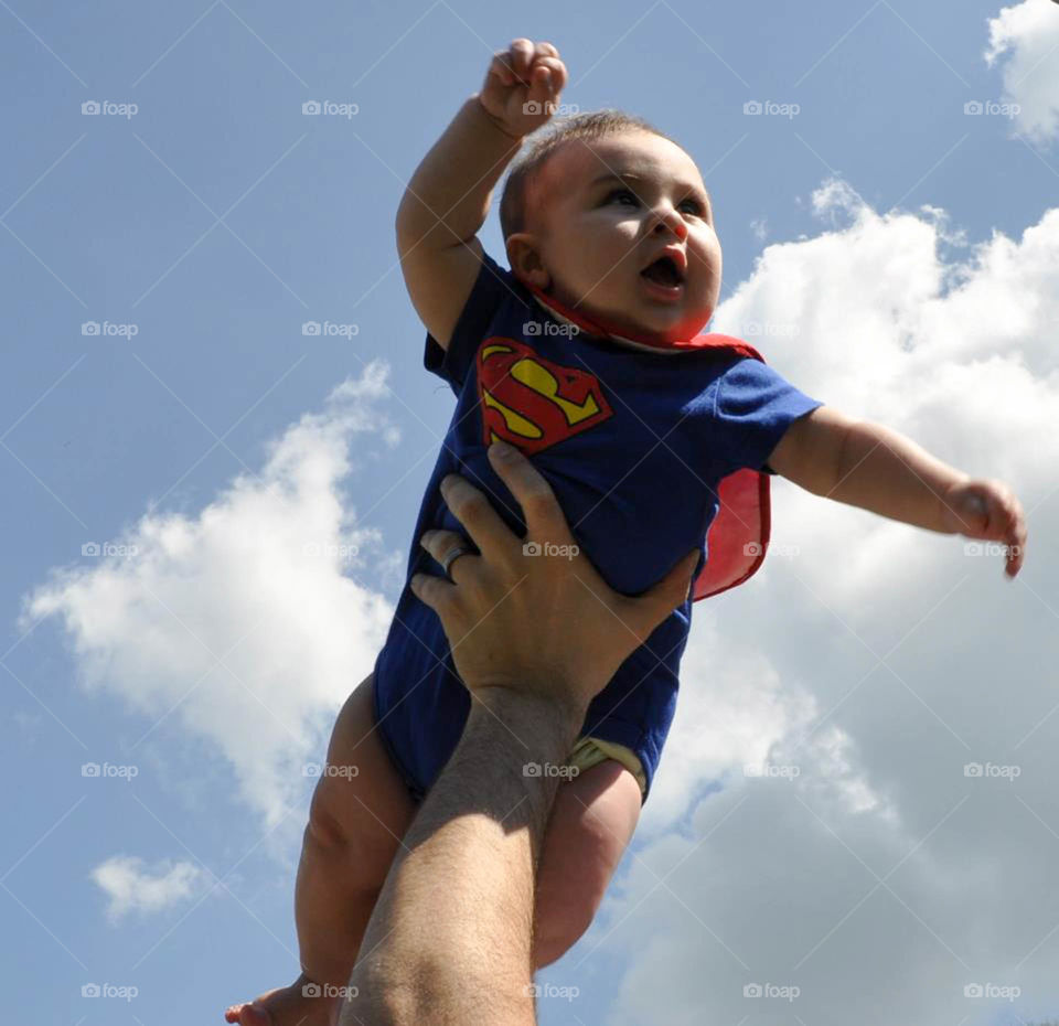 super baby. Baby flies high like Superman