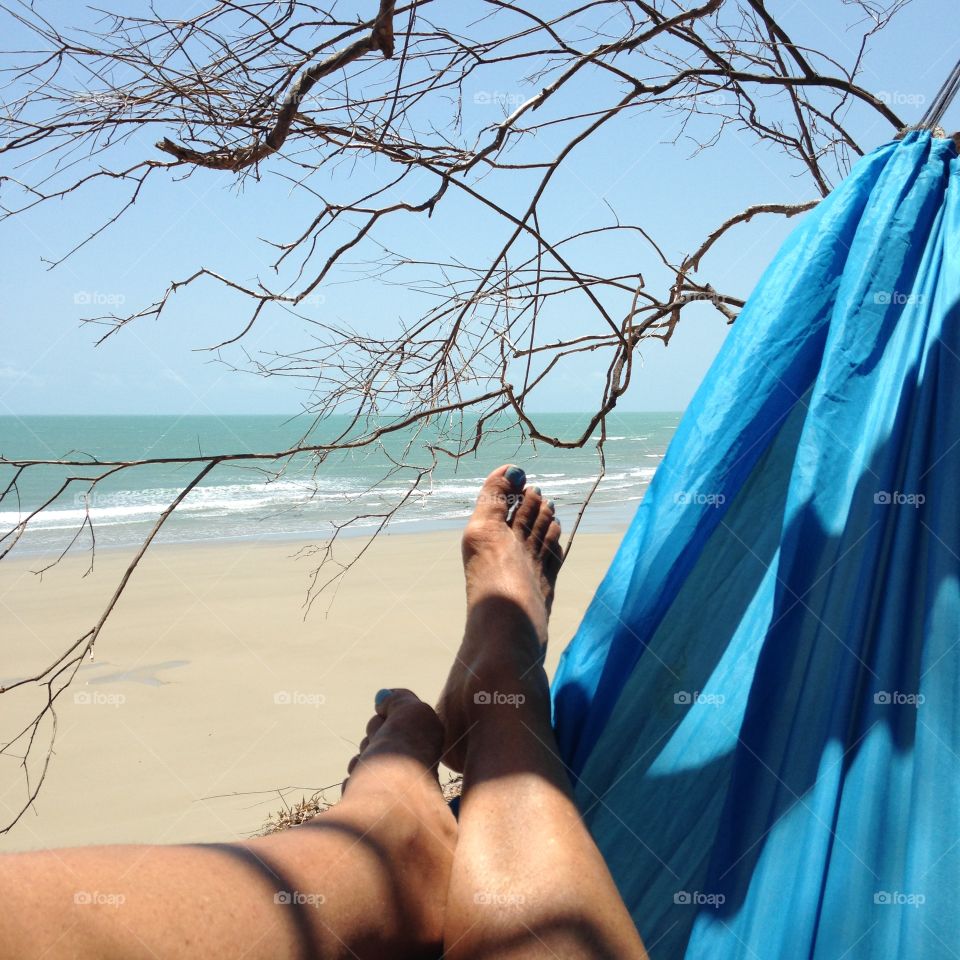 Perfect life. Enjoying the beach view on a hammock