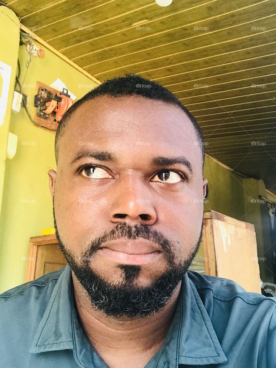 A man with a serious face is what i can see in this bright selfie photo. 