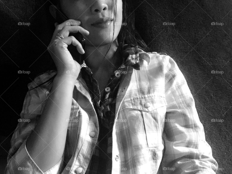 A woman in plaid making a call