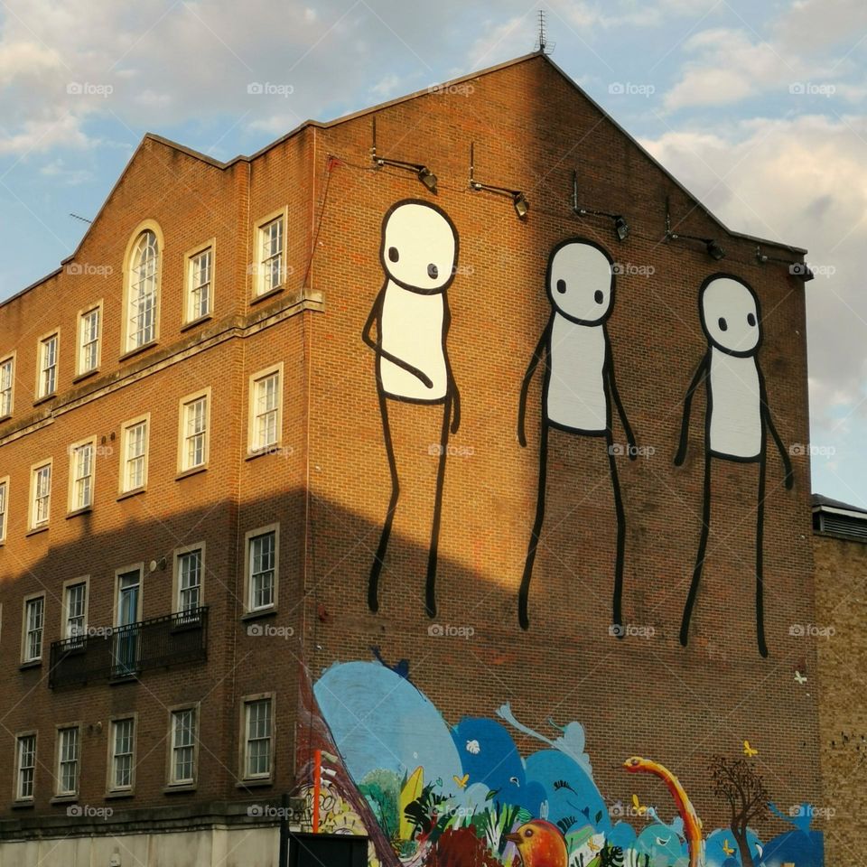 Visual street art in the city. Murals and graffiti in London streets.