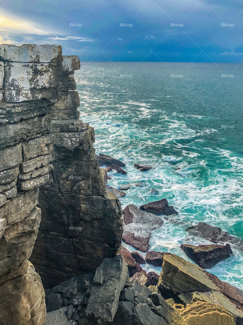 A view of the Atlantic Ocean from the jagged rocks of the Peniche peninsula in Portugal. Looks as though a storm might be brewing out at sea