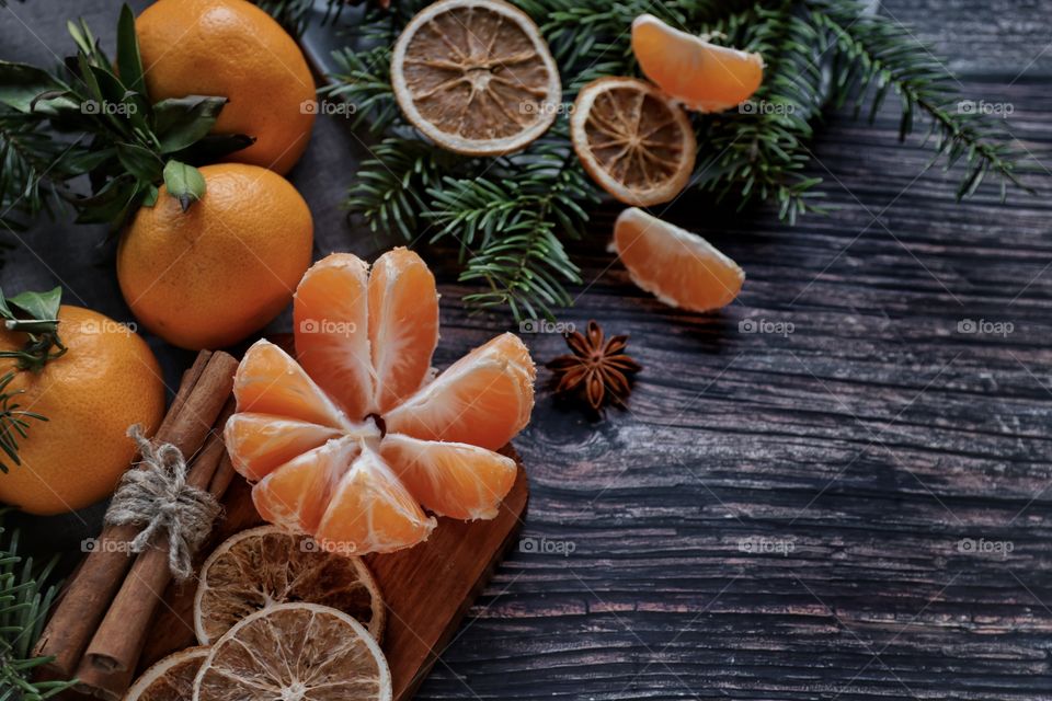 Flatlay mandarin orange cinnamon and Christmas tree branches 