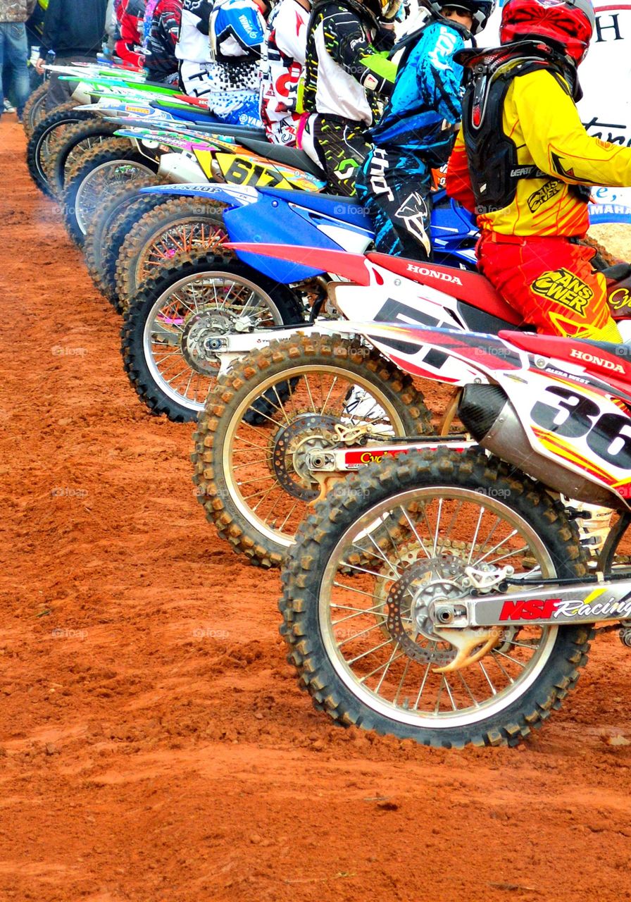 at the line. dirt bike rides waiting before the gate drops for the next motocross race