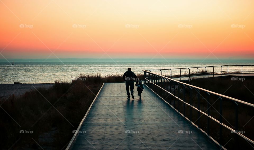 Dad and son running together