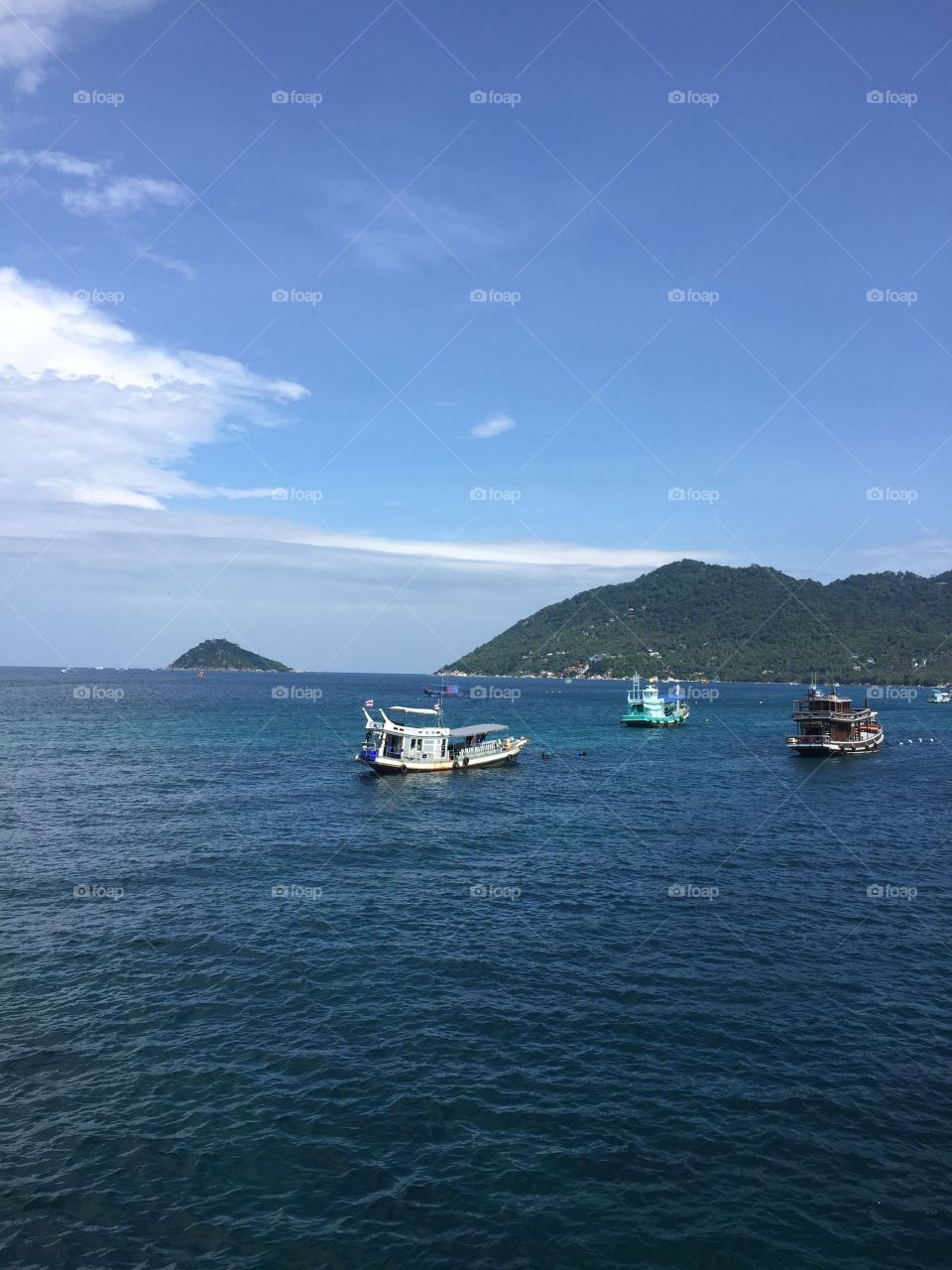 Thailand islands are the best, blue seas and skies. Mountains on the horizon and no pollution 