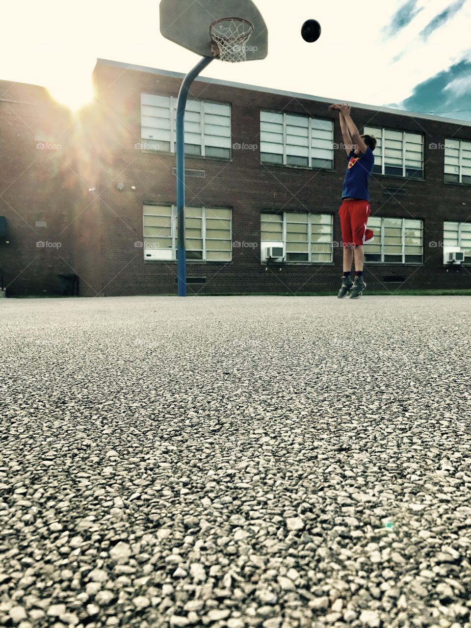 School student playing basketball