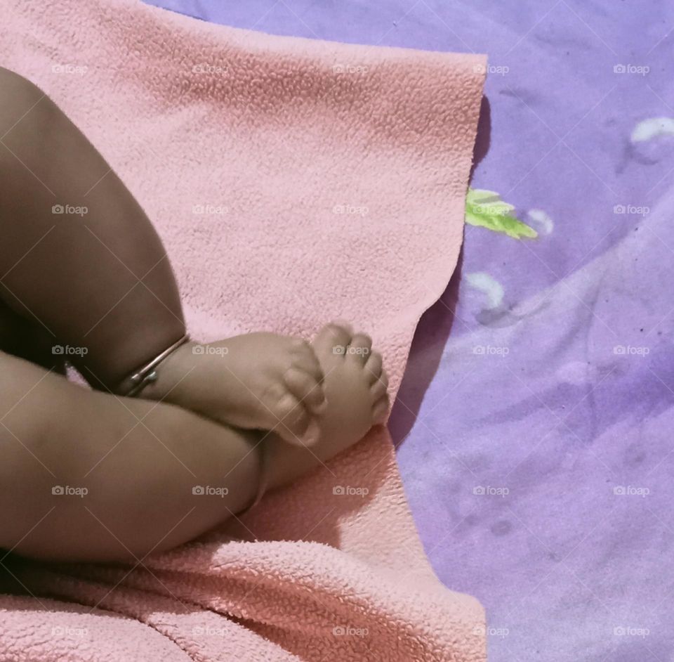 This beautiful ❤️😍 legs of two months baby girl 🐥😍. Baby is sleeping in her bed and playing joyfully with her toys!!🪀🧸