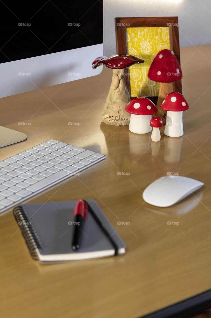 Desk with computer and mushroom themed ornaments 