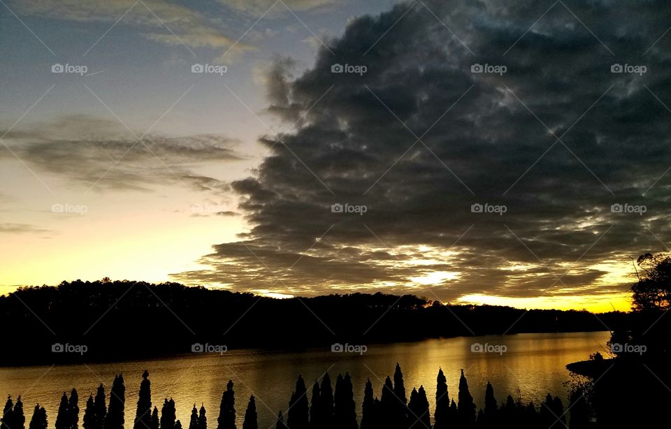 sunset clouds island and lake