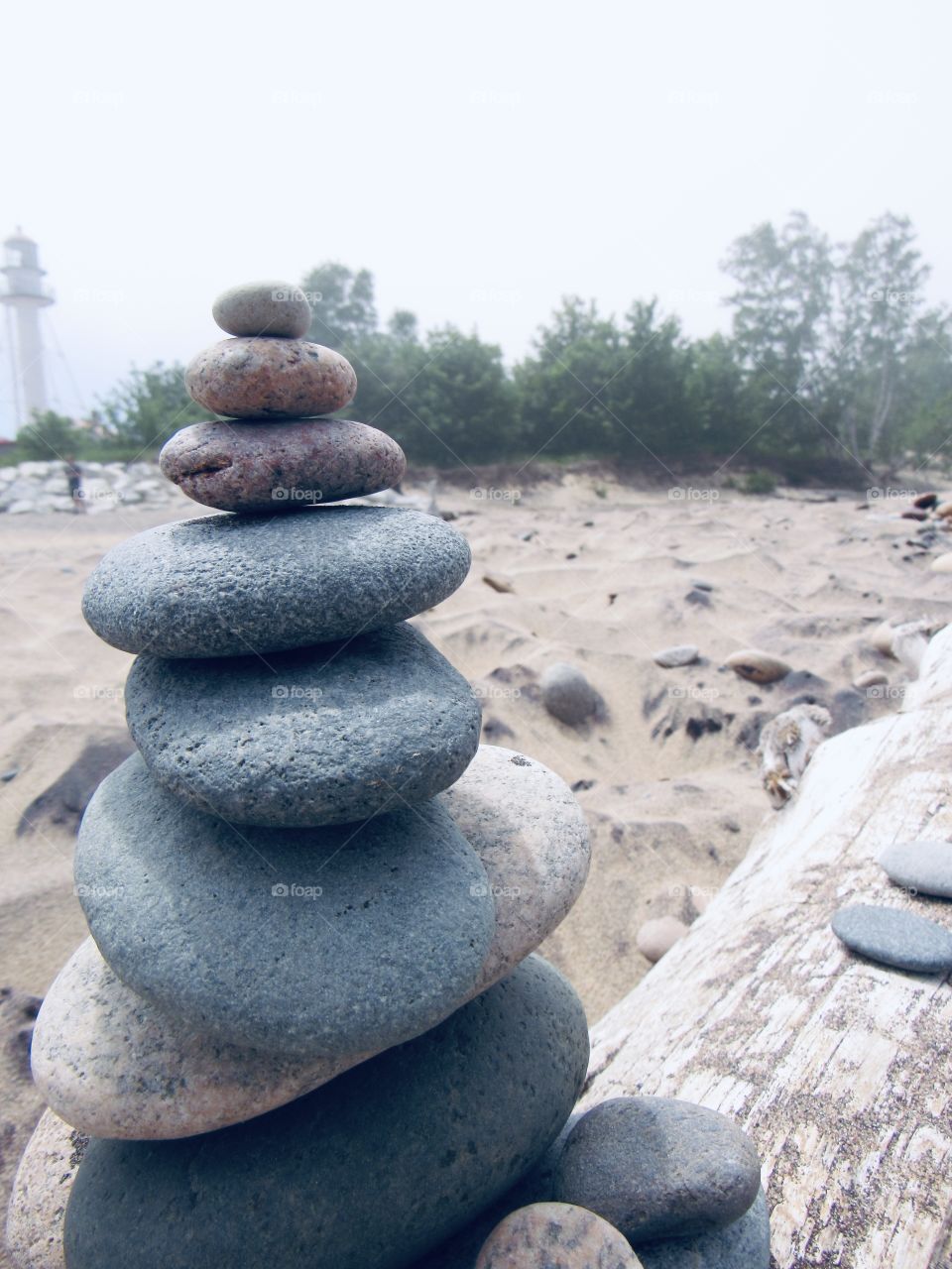 Stacked rocks on log