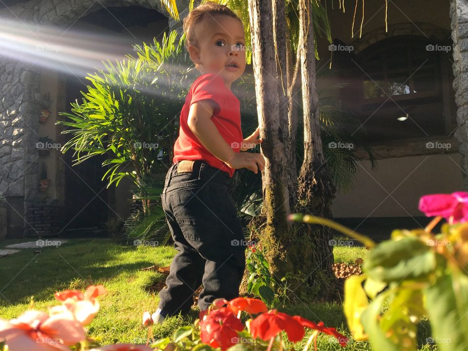 Close-up of a cute boy standing near house