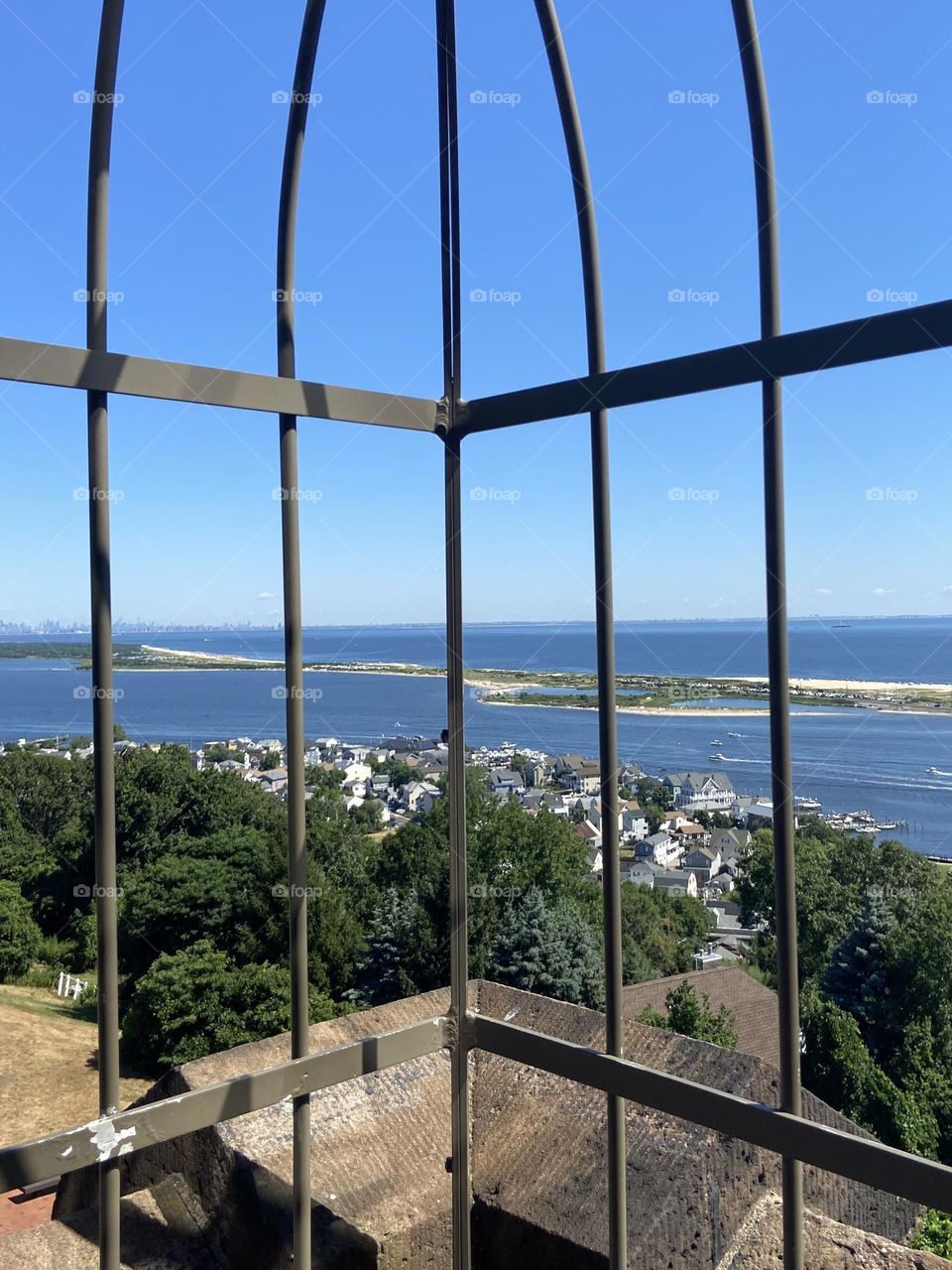 A view of the water from the “almost top” of one of two lighthouses at the Twin Lights Historic Site in Atlantic Highlands, NJ. The site overlooks the Shrewsbury River, Sandy Hook, Raritan Bay, the Atlantic Ocean, and the New York City skyline.