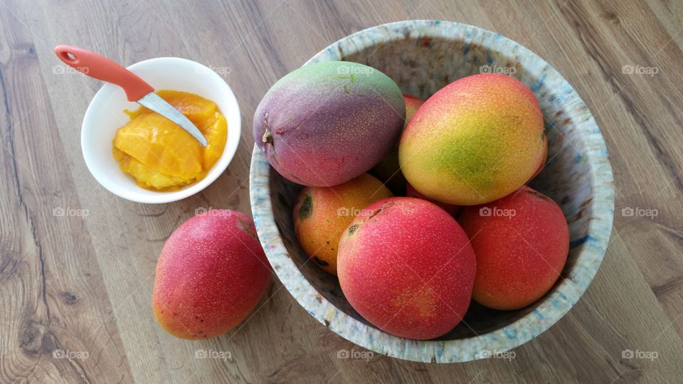 High angle view of ripe mangoes in bowl