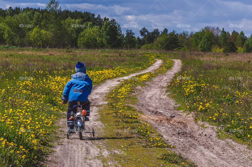 Little boy on his bike in the countryside