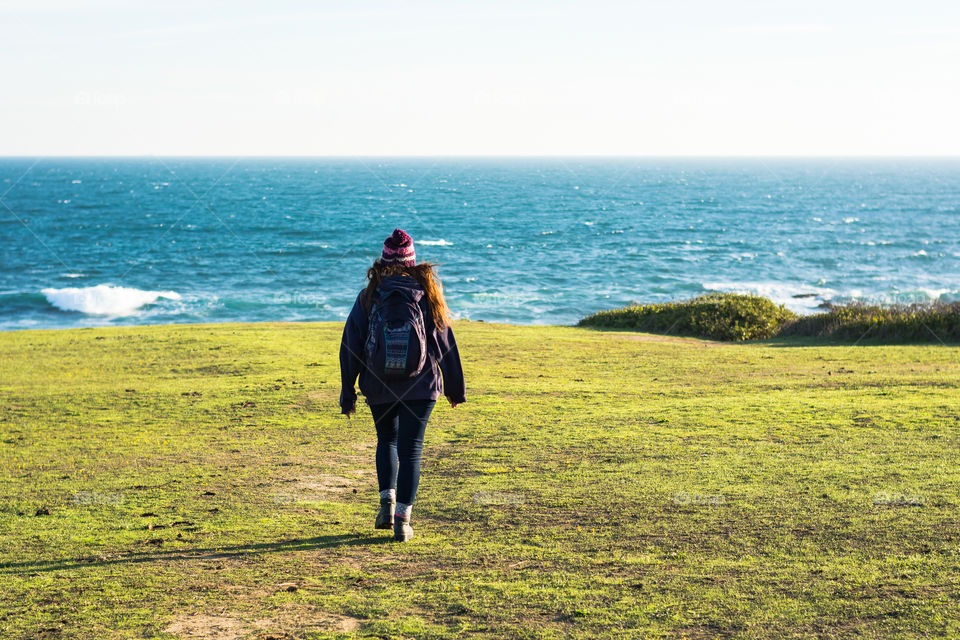 Girl walking to the sea 
