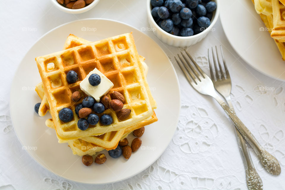 Belgian waffles with butter, blueberry and nuts