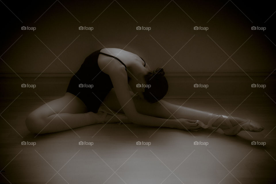 Beautiful ballet dancer on black background