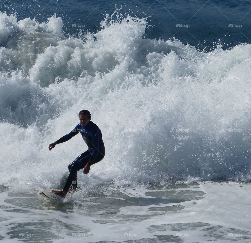 Silhouette of surfer finishing ride