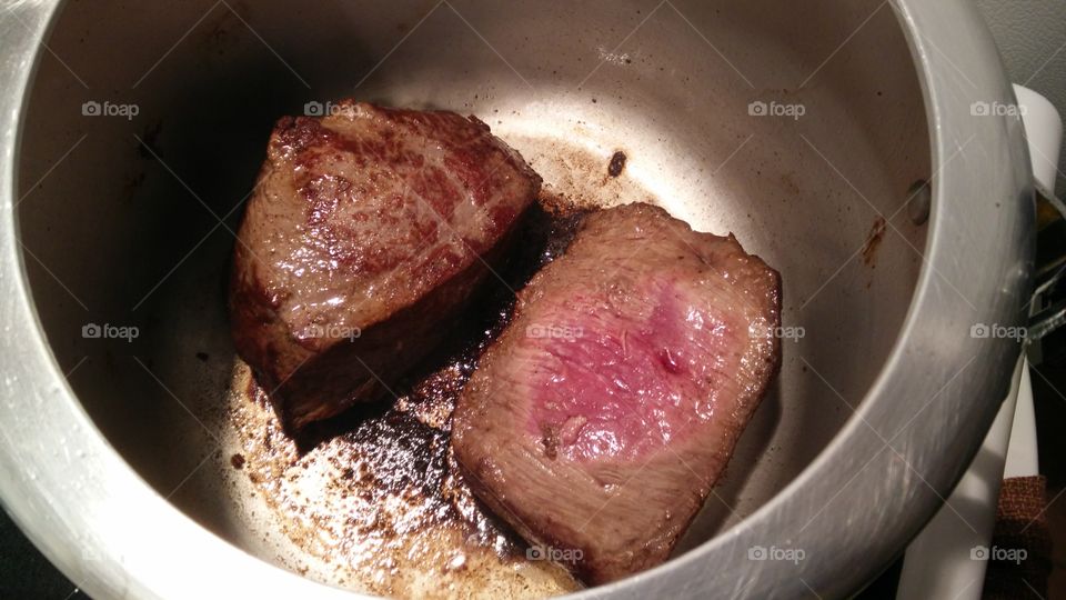 beef roasted browning on pressured cooking pot