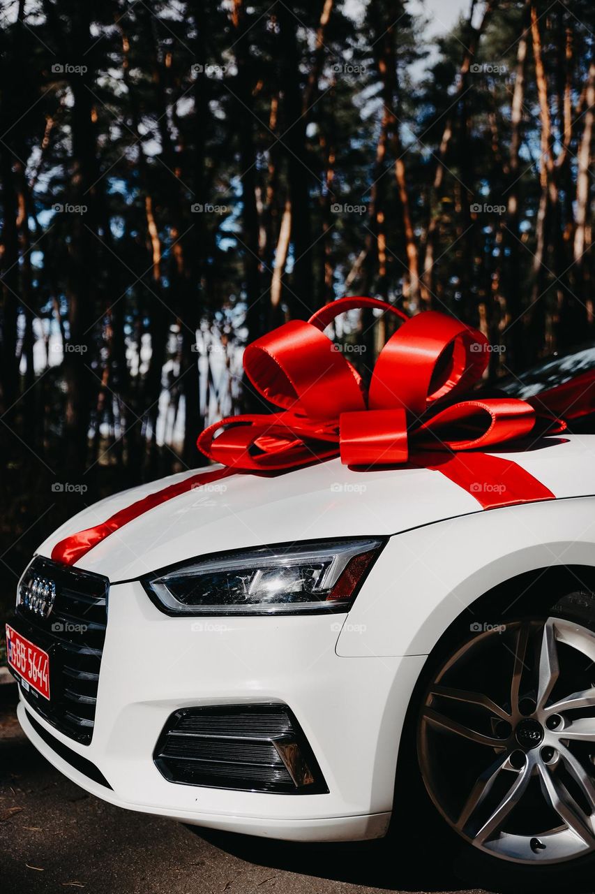 Surprise white audi with red ribbon