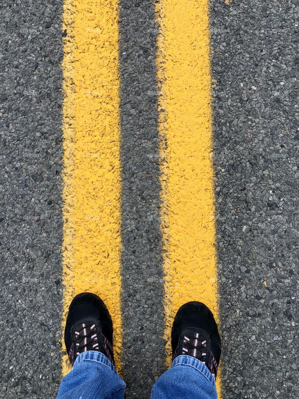 My Feet On The Double No Passing Line

I'm standing on the highway with no traffic coming, luckily. 
The lines mean NO PASSING!