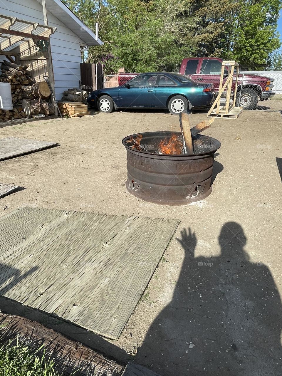 Having a firepit during the day and a shadow saying hello