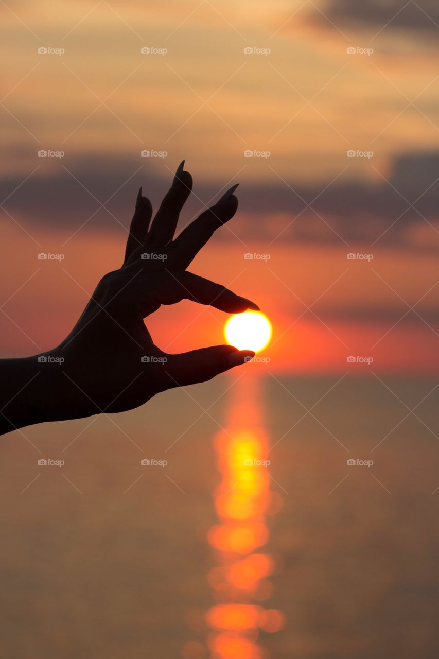 Human hand holding sun