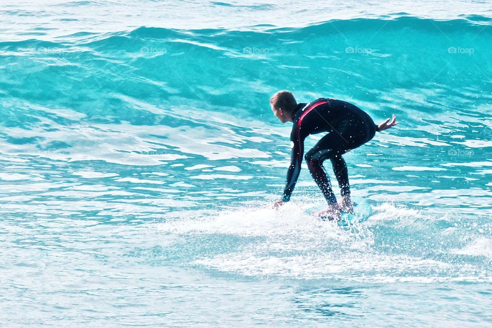 A surfer attempting to catch a wave in Laguna Beach California 