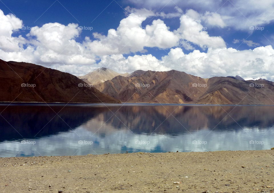 Mountains and clouds reflection in water