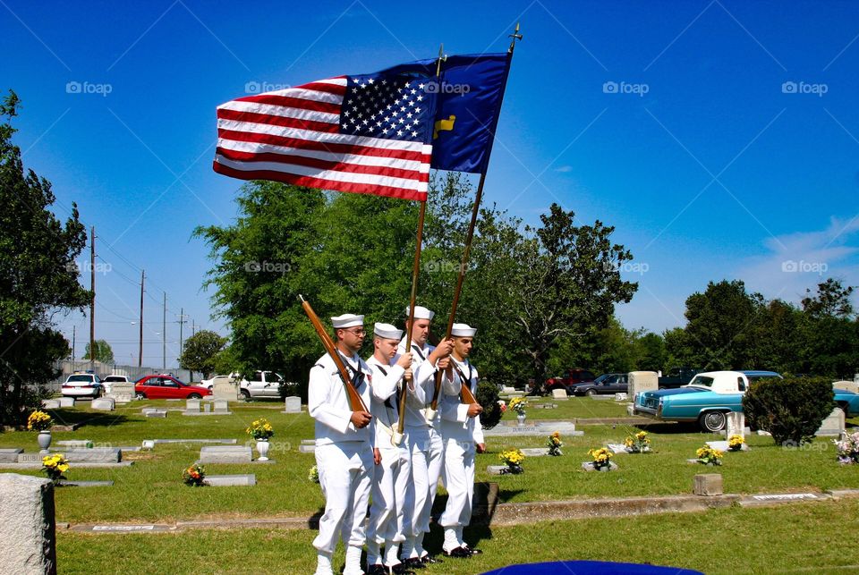Navy Honor Guard marches during veteran’s funeral 