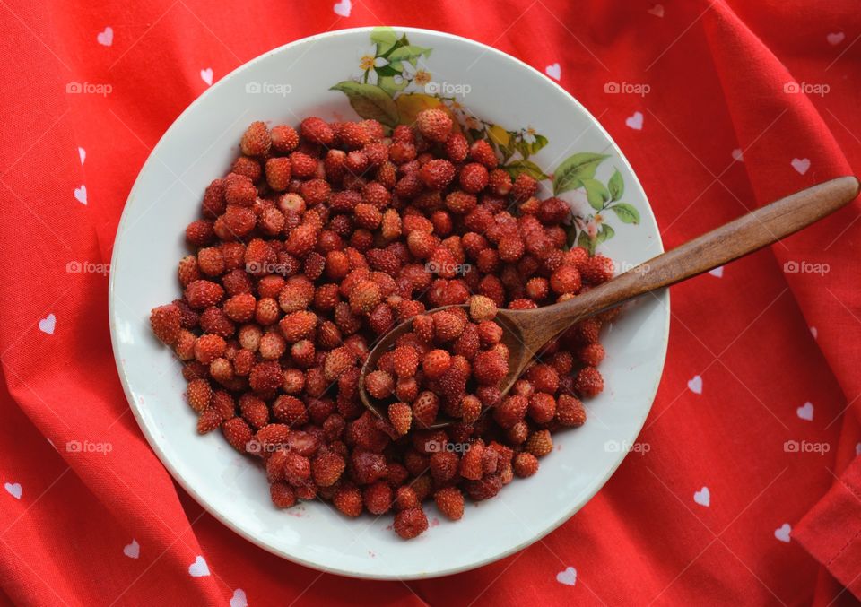 red strawberries on a plate tasty healthy summer food red background