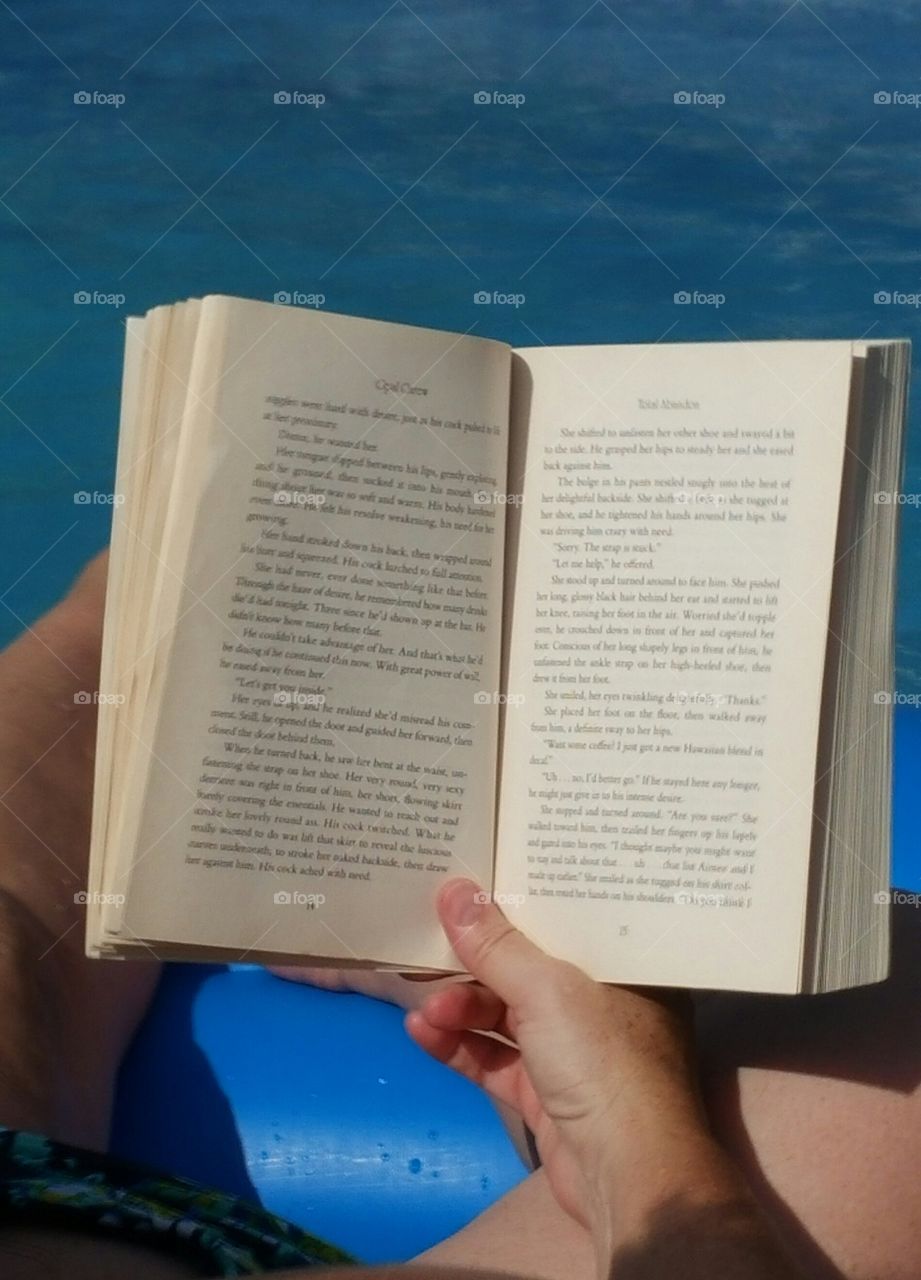 reading book in pool