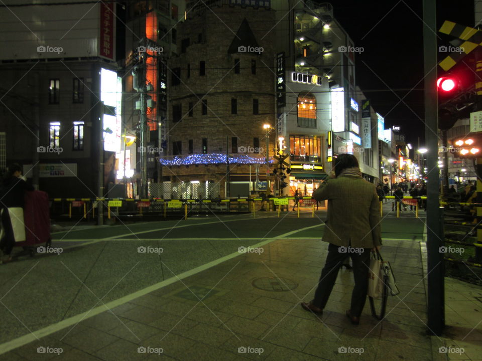 Jiyugaoka, Tokyo, Japan.  Night View of Street and City Lights. Fashionable Man Standing on the Street