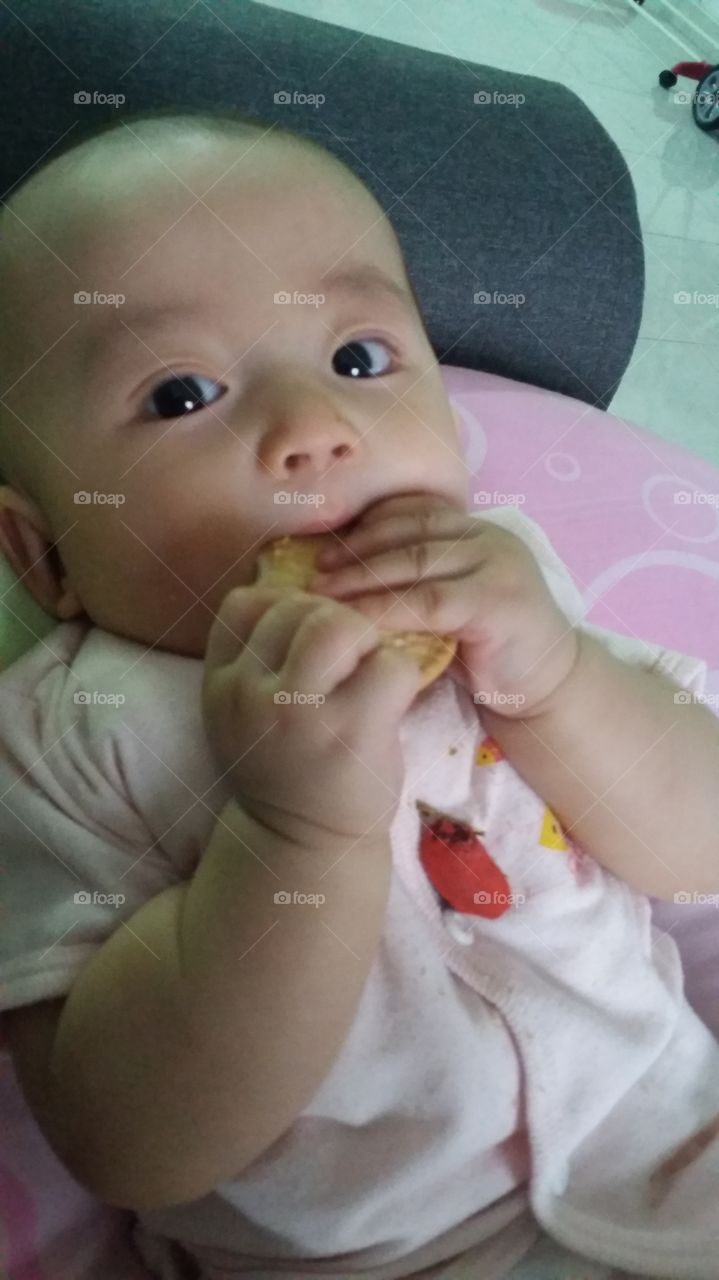my precious baby keanna eating biscuit.