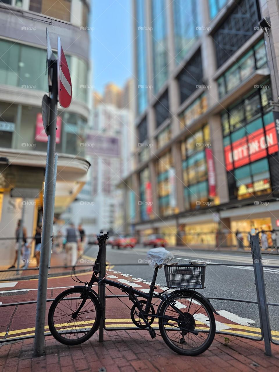 One lonely bicycle parked on the street corner