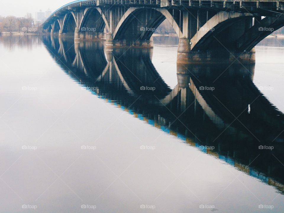 reflection of the bridge in the Dnieper river